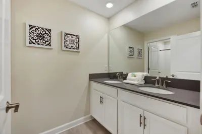 a bathroom with two sinks and a mirror at Barefoot Breeze - Storey Lake by Shine Villas #833 townhouse in Kissimmee
