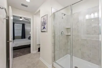 a bathroom with a shower and a glass shower stall at Serenity Haven, Bliss, Storey Lake by Shine Villas condo in Kissimmee
