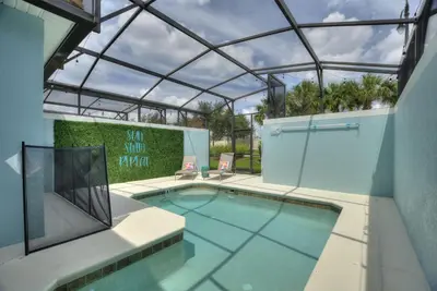 an indoor swimming pool with a glass roof at Haven Station at Storey Lake by Shine Villas townhouse in Kissimmee