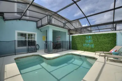 a large swimming pool in a house with a roof at Haven Station at Storey Lake by Shine Villas townhouse in Kissimmee