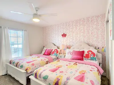 two beds in a girls bedroom with pink and white at Happy Haven at Storey Lake Resort by Shine Villas condo in Kissimmee