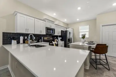 a kitchen with white cabinets and a white counter top at Lake View at Storey Lake by Shine Villas #703 apts in Kissimmee