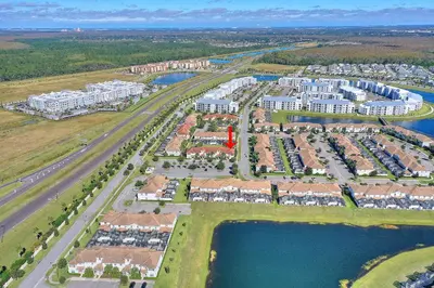 an aerial view of a large apartment complex next to the water at Lazy Life at Storey Lake by Shine Villas #901 condo in Kissimmee