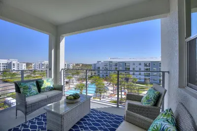 a balcony with chairs and a table on a balcony at Duck House at Storey Lake by Shine Villas #992 apts in Kissimmee