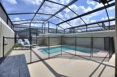 a swimming pool with a glass roof on a balcony at Plush Pelican, at Storey Lake by Shine Villas #839 home in Kissimmee