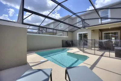 a swimming pool in the middle of a house at Plush Pelican, at Storey Lake by Shine Villas #839 home in Kissimmee