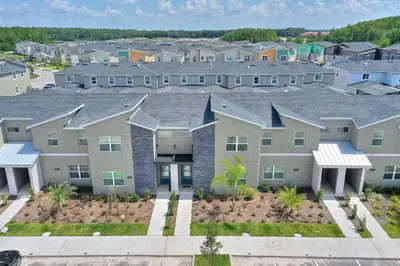 an aerial view of a row of apartment buildings at Plush Pelican, at Storey Lake by Shine Villas #839 home in Kissimmee