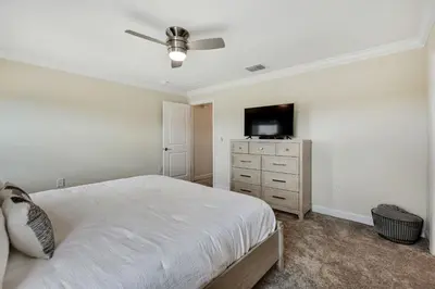 a bedroom with a bed and a flat screen tv at Magic Lily - Storey Lake by Shine Villas #834 townhouse in Kissimmee