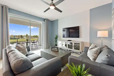 a living room with a couch and a tv at Decadent Penguin - Storey Lake by Shine Villas 704 apts in Kissimmee