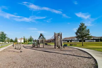a playground in a park with a slide at Star Hideaway at Storey Lake by Shine Villas townhouse in Kissimmee