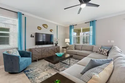 a living room with a couch and a tv at Water Kingdom Storey Lake by Shine Villas! #525 home in Kissimmee