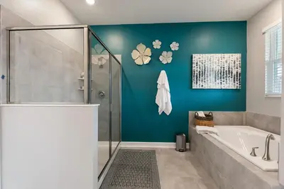 a bathroom with a shower and a bath tub at Water Kingdom Storey Lake by Shine Villas! #525 home in Kissimmee