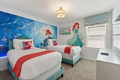 a bedroom with two beds and a mermaid mural at Sea Shore at Solara Resort by Shine Villas #401 villa in Orlando