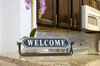 a welcome sign on a counter in a kitchen at Your Orlando stay 15 min to Disney - DVH01 in Kissimmee