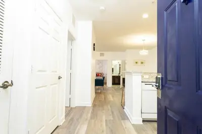 a hallway with a blue door and a kitchen at Your Orlando stay 15 min to Disney - DVH01 in Kissimmee