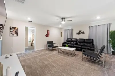 a living room with a couch and a table at Treat Retreat Storey Lake by Shine Villas #418 villa in Kissimmee