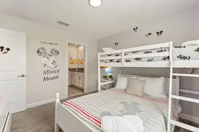 a bedroom with two bunk beds in a room at Treat Retreat Storey Lake by Shine Villas #418 villa in Kissimmee