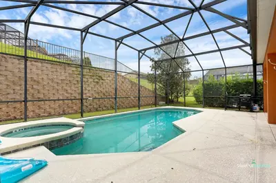 an indoor swimming pool with a glass roof at Private Pool, Spa Tub, Themed Rooms, Resort Amenities in Kissimmee