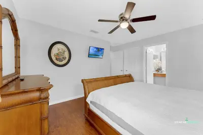 a bedroom with a bed and a ceiling fan at Private Pool, Spa Tub, Themed Rooms, Resort Amenities in Kissimmee