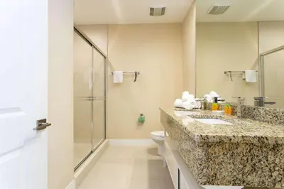 a bathroom with a toilet and a sink and a shower at Gorgeous 4 Bd Close to Disney @ Magic Village 3114 in Orlando