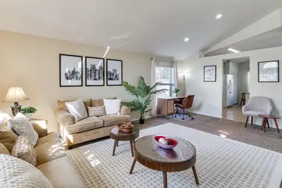 a living room with a couch and a table at Pool and Hot Tub Home 17 Mi to Epic Universe! in Kissimmee