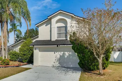 a house with a white garage at Pool and Hot Tub Home 17 Mi to Epic Universe! in Kissimmee