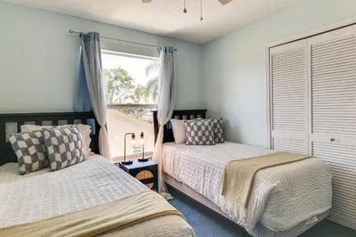 a bedroom with two beds and a window at Pool and Hot Tub Home 17 Mi to Epic Universe! in Kissimmee