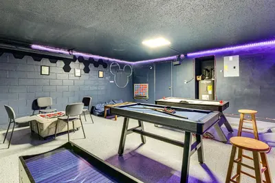 a ping pong room with a ping pong table and chairs at Pool and Hot Tub Home 17 Mi to Epic Universe! in Kissimmee