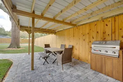 a patio with a grill and a table and chairs at Apopka Home with Yard and Grill Near Wekiwa Springs! in Apopka