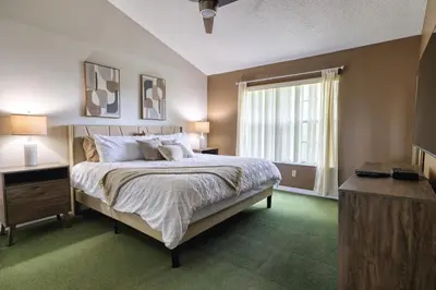 a bedroom with a large bed and a window at Laguna Bay 2 Bedroom Condo Resort Pool 8 Miles to Disney in Kissimmee