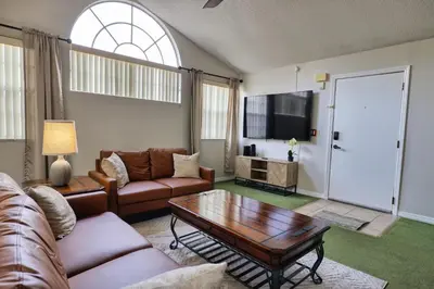 a living room with a couch and a coffee table at Laguna Bay 2 Bedroom Condo Resort Pool 8 Miles to Disney in Kissimmee