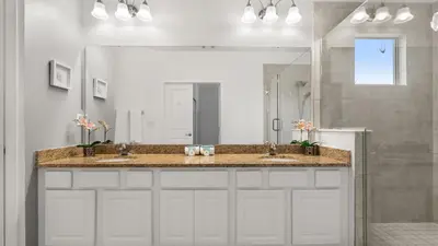 a bathroom with two sinks and a large mirror at 6BR Luxury Home with Private Pool and BBQ in Kissimmee