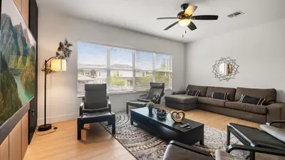 a living room with a couch and a table at 6BR Luxury Home with Private Pool and BBQ in Kissimmee