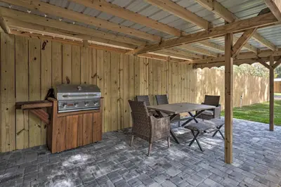 a patio with a grill and a table and chairs at Apopka Getaway with Yard and Covered Patio in Apopka