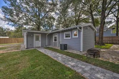 a small grey house with a grill in a yard at Apopka Getaway with Yard and Covered Patio in Apopka