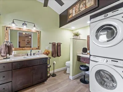 a bathroom with a washing machine and a sink at College Park-Orlando 5Star Villa Oasis - Home Away From Home - QUIET Neighborhood-PRIVATE Botanical Courtyard - mins from EOLA,DT, Winter Park - Free Parking & EV Plug In in Orlando