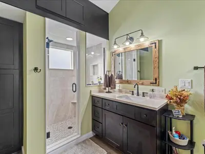 a bathroom with a shower and a sink and a mirror at College Park-Orlando 5Star Villa Oasis - Home Away From Home - QUIET Neighborhood-PRIVATE Botanical Courtyard - mins from EOLA,DT, Winter Park - Free Parking & EV Plug In in Orlando