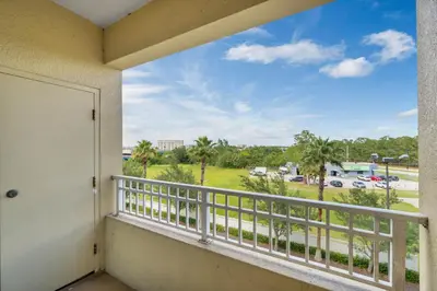 a balcony with a view of a parking lot at The Point, Lux Apartment 4 min from Universal in Orlando