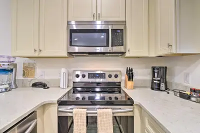 a kitchen with a stove and a microwave at Tropical Cottage with Hot Tub Near Disney! in Orlando