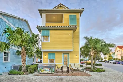 a yellow house with a table in front of it at Tropical Cottage with Hot Tub Near Disney! in Orlando