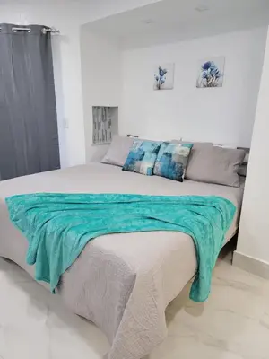 a bedroom with a large bed with a blue blanket on it at 3509 Luxury Location and Location in Orlando