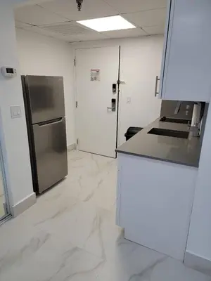 a kitchen with a refrigerator and a counter top at 3509 Luxury Location and Location in Orlando