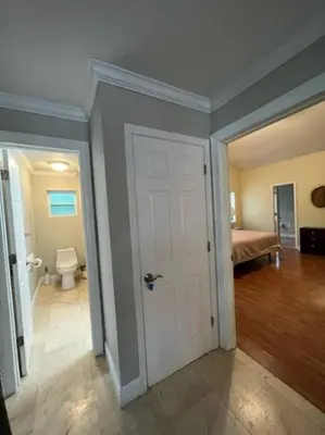 a room with a door and a bathroom with a toilet at Resort Like house, 4 bedrooms, 3 bathrooms in Orlando