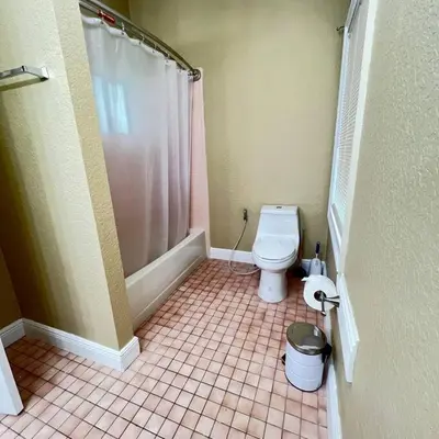 a small bathroom with a toilet and a shower at Resort Like house, 4 bedrooms, 3 bathrooms in Orlando