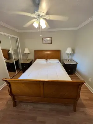 a large bed in a bedroom with two night stands at Resort Like house, 4 bedrooms, 3 bathrooms in Orlando