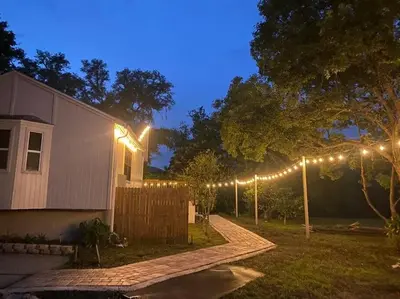 a house with lights in the yard at night at Resort Like house, 4 bedrooms, 3 bathrooms in Orlando