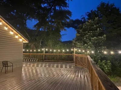 a wooden deck with lights on the side of a house at Resort Like house, 4 bedrooms, 3 bathrooms in Orlando