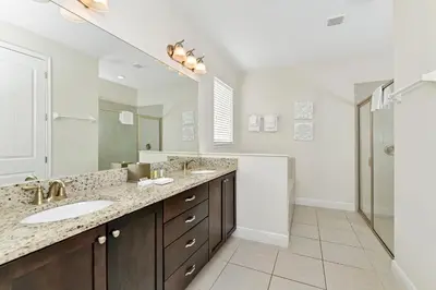 a bathroom with two sinks and a large mirror at Vibrant Home Near Disney With Private Pool, Waterpark And Resort Acces At Encore Resorts Reunion - 221Fl in Kissimmee