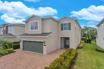 a large white house with a garage at 7462 Themed Villa 6BD - Pool Spa-Game room in Orlando