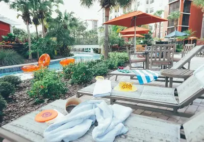 a patio with a table and chairs and a pool at Amazing Private Villa @ Orang Lake Resort in Orlando